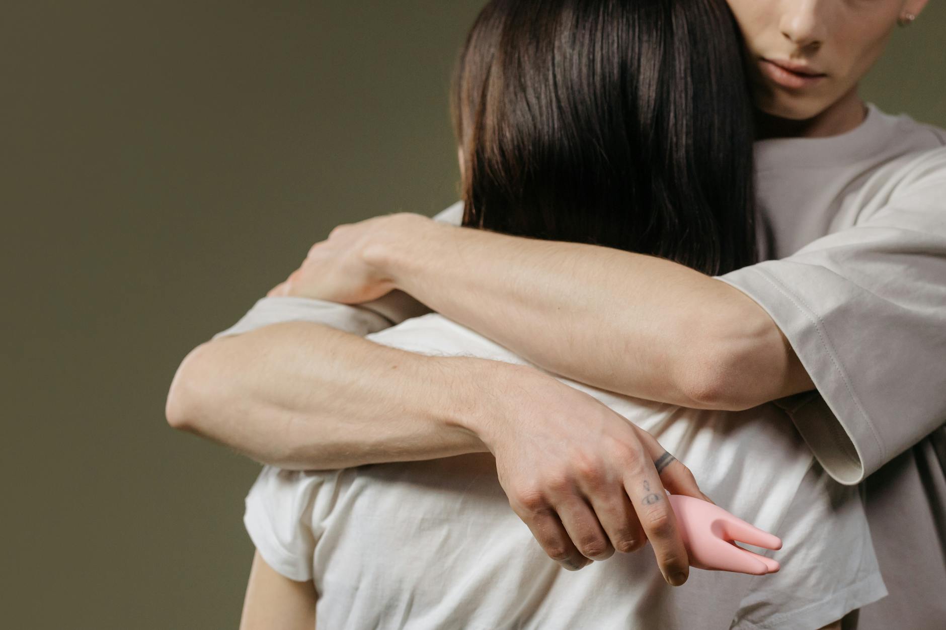 A couple holding a vibrator together, symbolizing modern intimacy and shared exploration